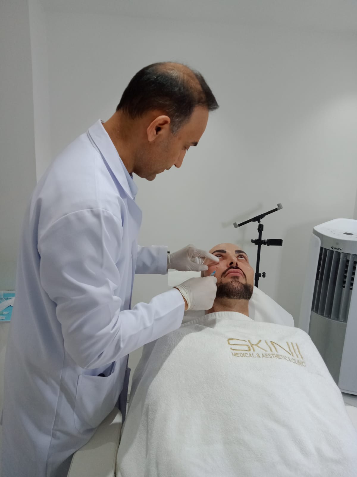 Dr. Zaheer Abbas working carefully during a facial treatment