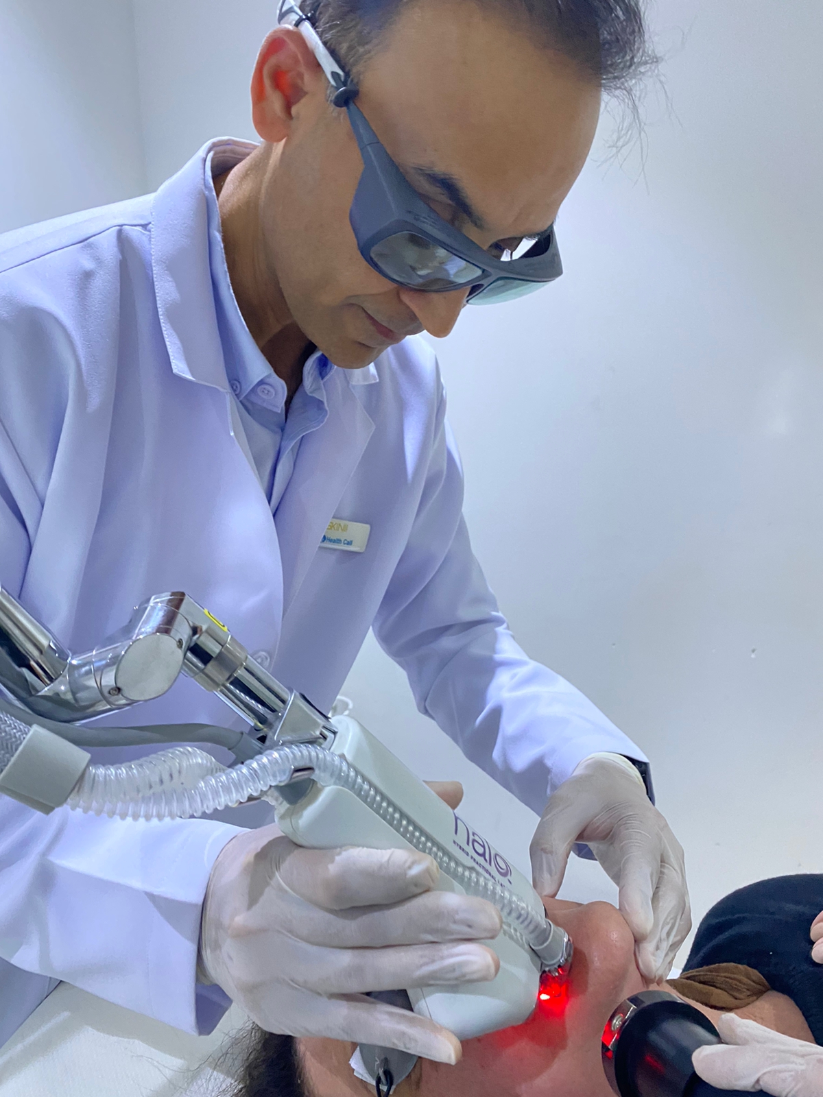 Dr. Zaheer Abbas wearing protective eyewear during a laser treatment